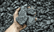 A hand holding some coal
