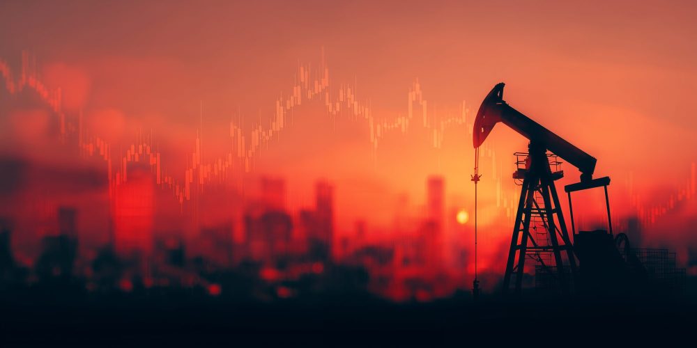 Silhouette of oil pump jack against a cityscape during sunset with falling stock graph